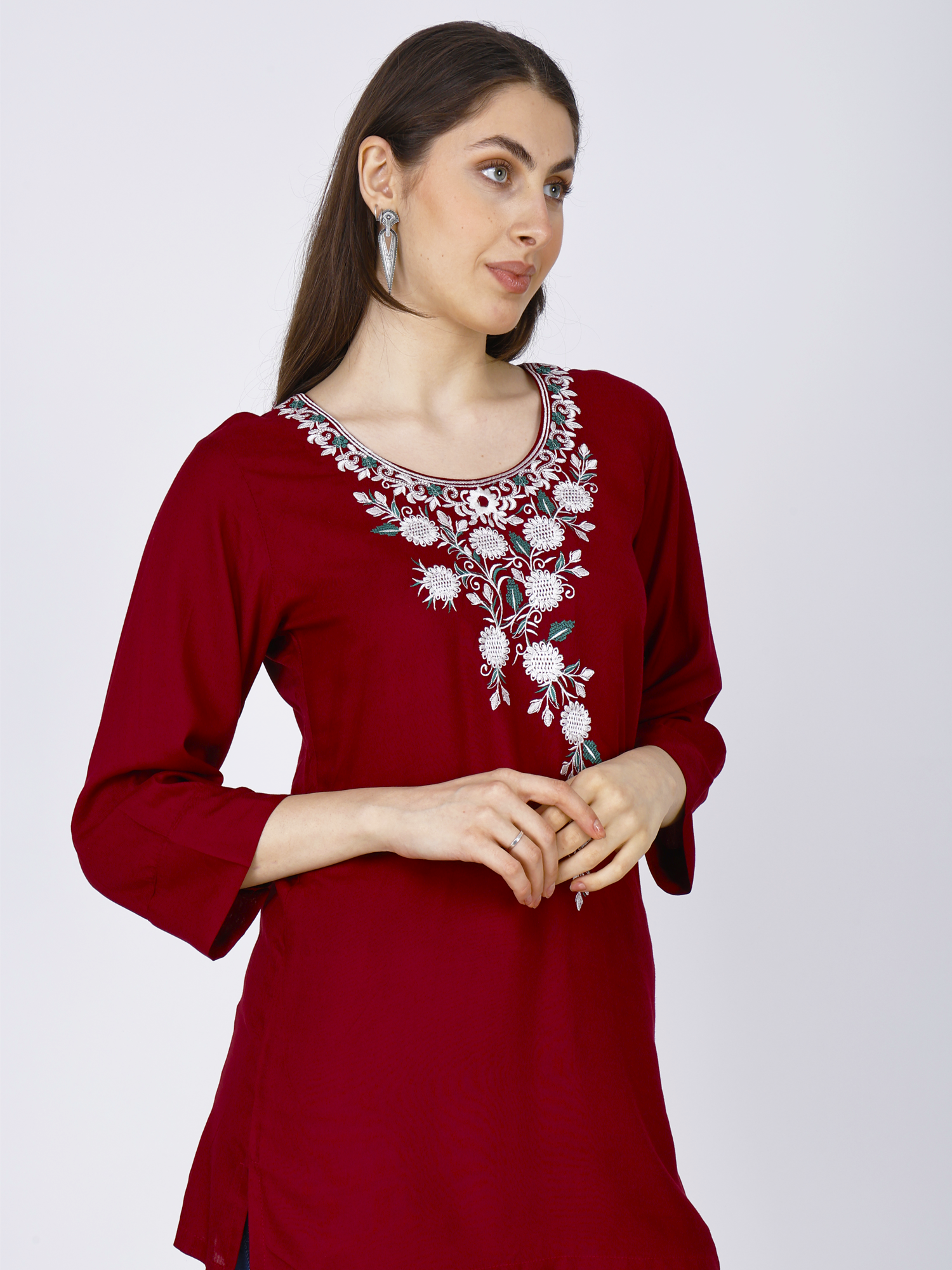 Women's red short kurti with white floral embroidery at neckline and front
