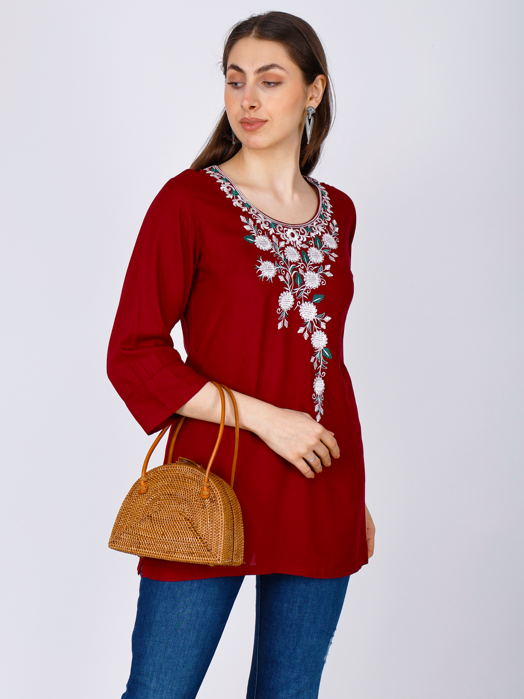 Women's red short kurti with white floral chest embroidery, side view