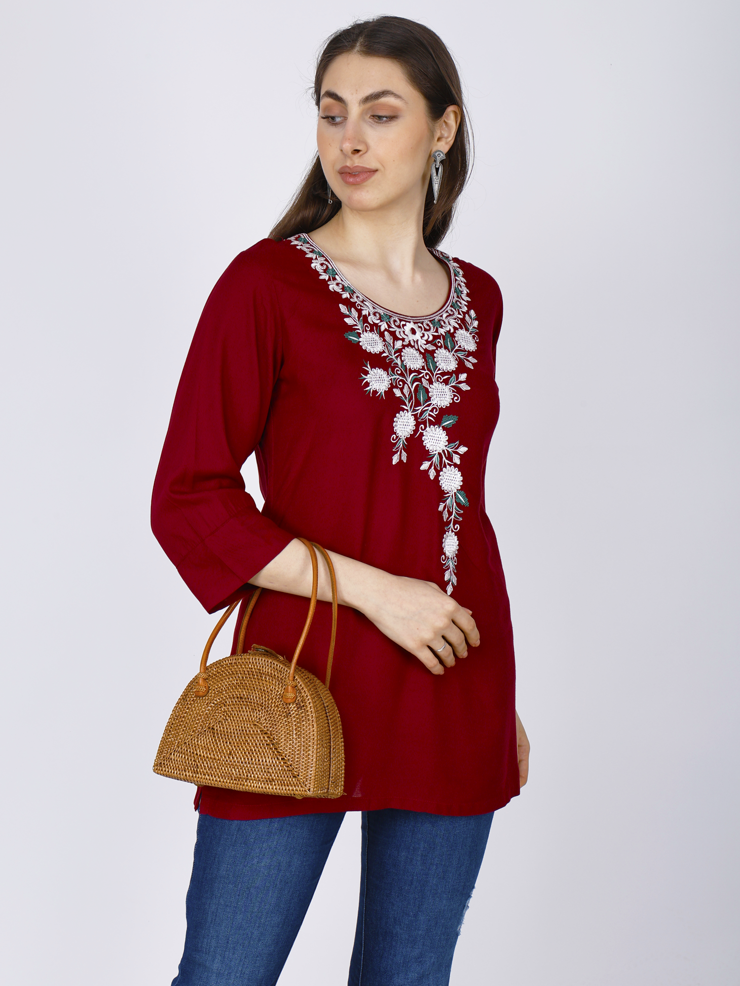 Women's red short kurti with white floral chest embroidery, side view