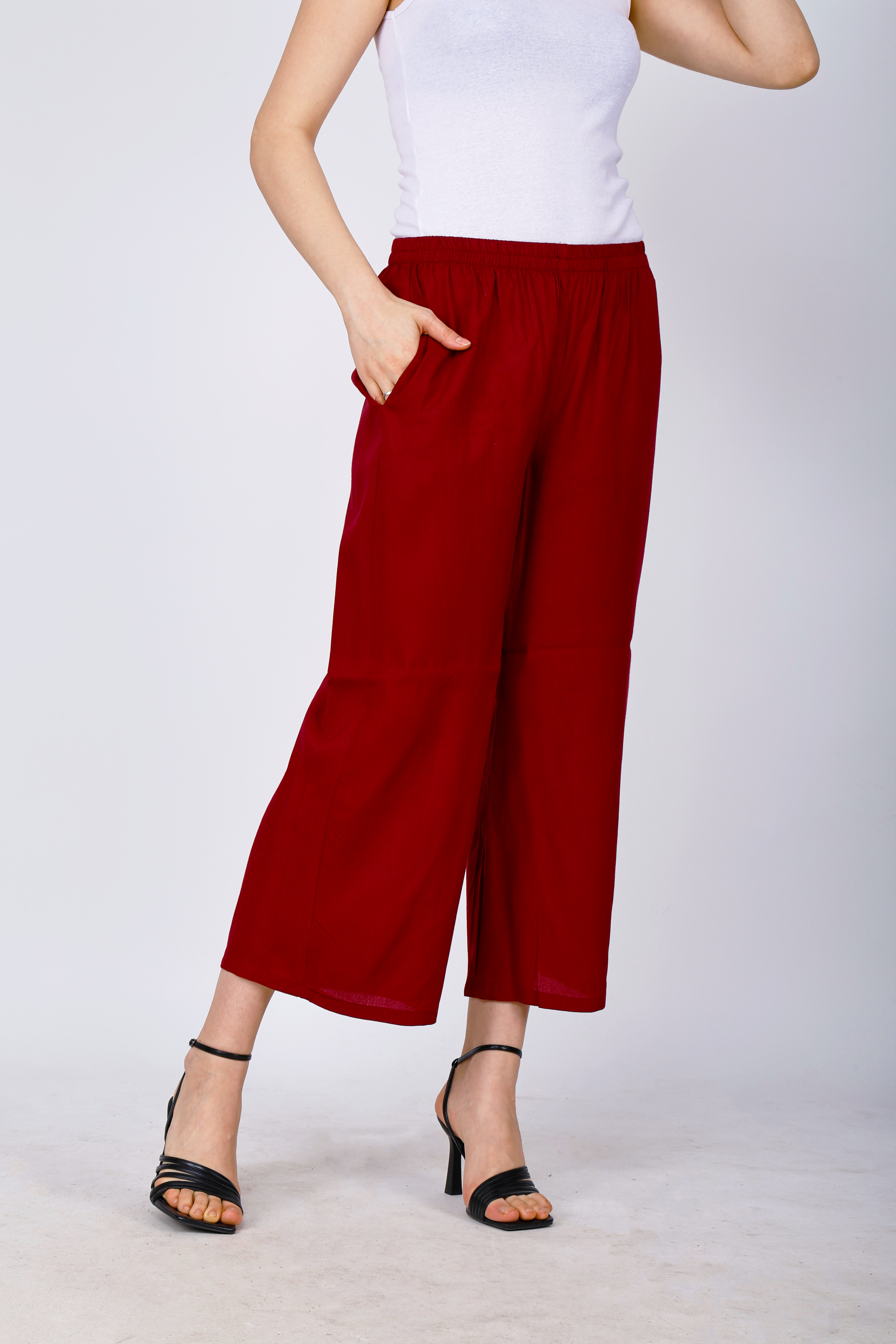 Women’s maroon palazzo pants, front side view, gathered elastic waist and flowy legs