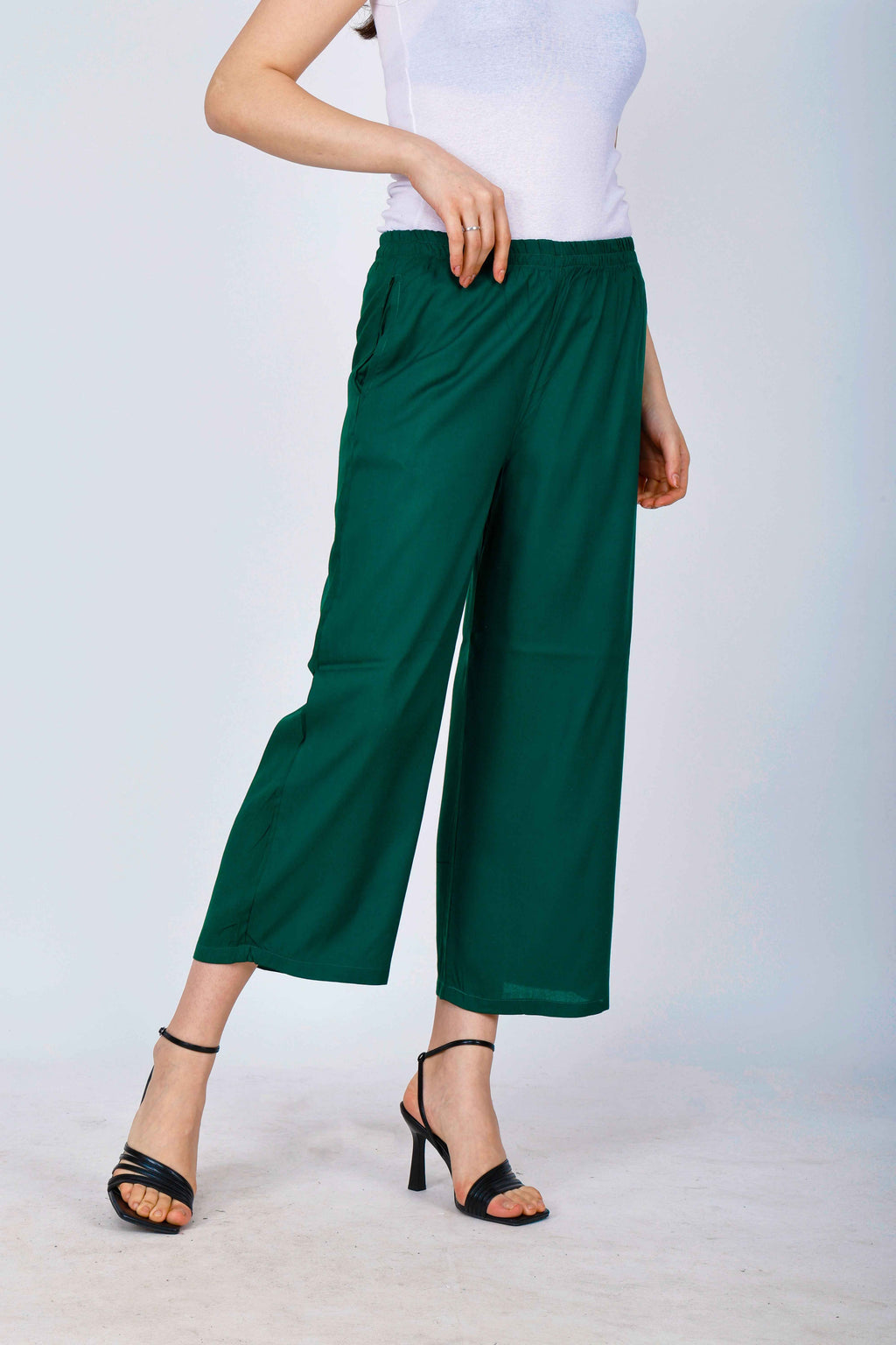 Women’s dark green palazzo pants, front view with wide legs and gathered elastic waist
