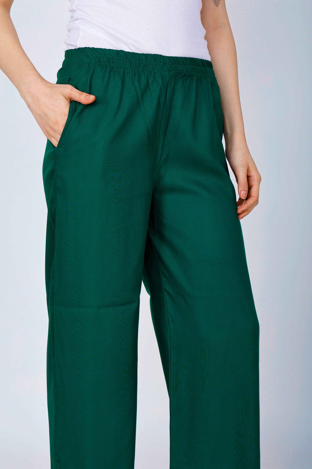 Women’s dark green palazzo pants close-up of elastic waistband and wide-leg fabric