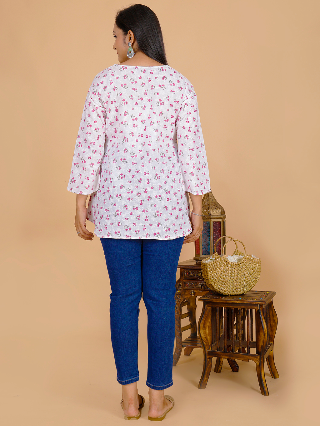 Floral tunic top back view, white with maroon/pink flower print, 3/4 sleeves