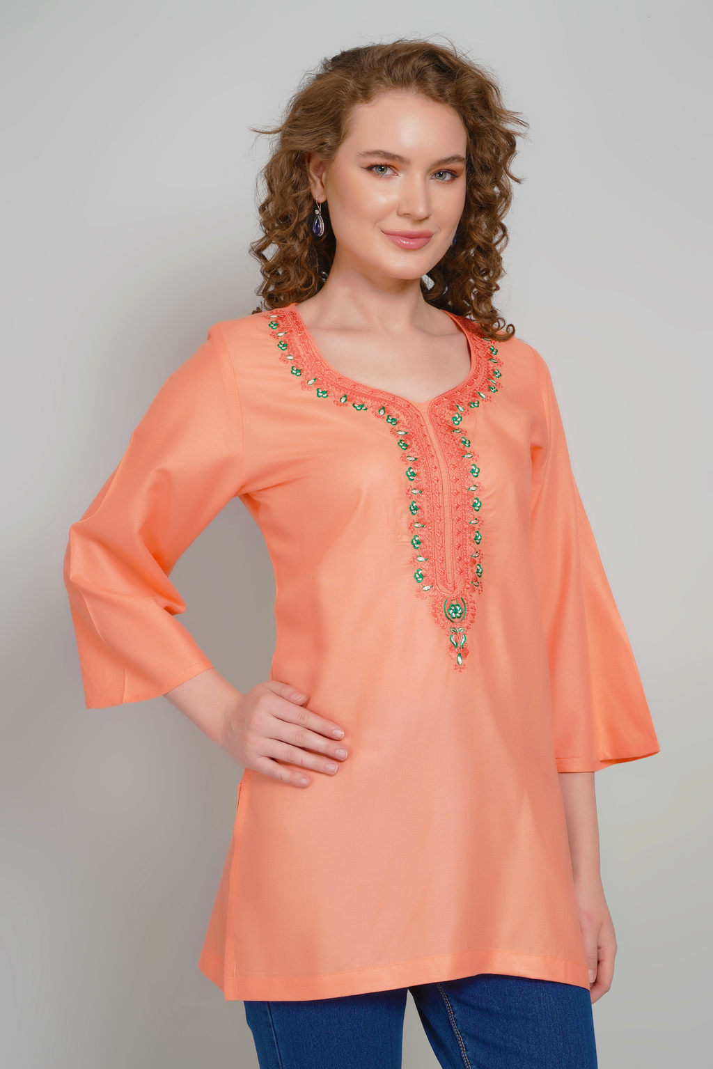 Women's peach-orange short kurti with colorful embroidered center neckline, three-quarter sleeves