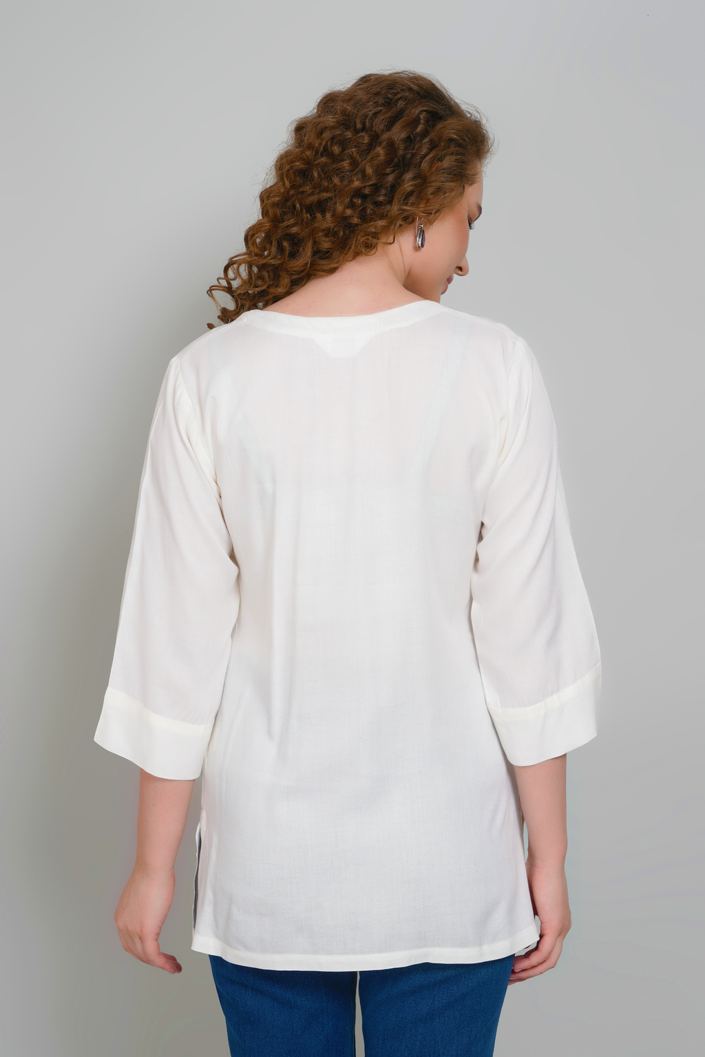 Women’s off-white tunic with 3/4 sleeves and back yoke seam detail