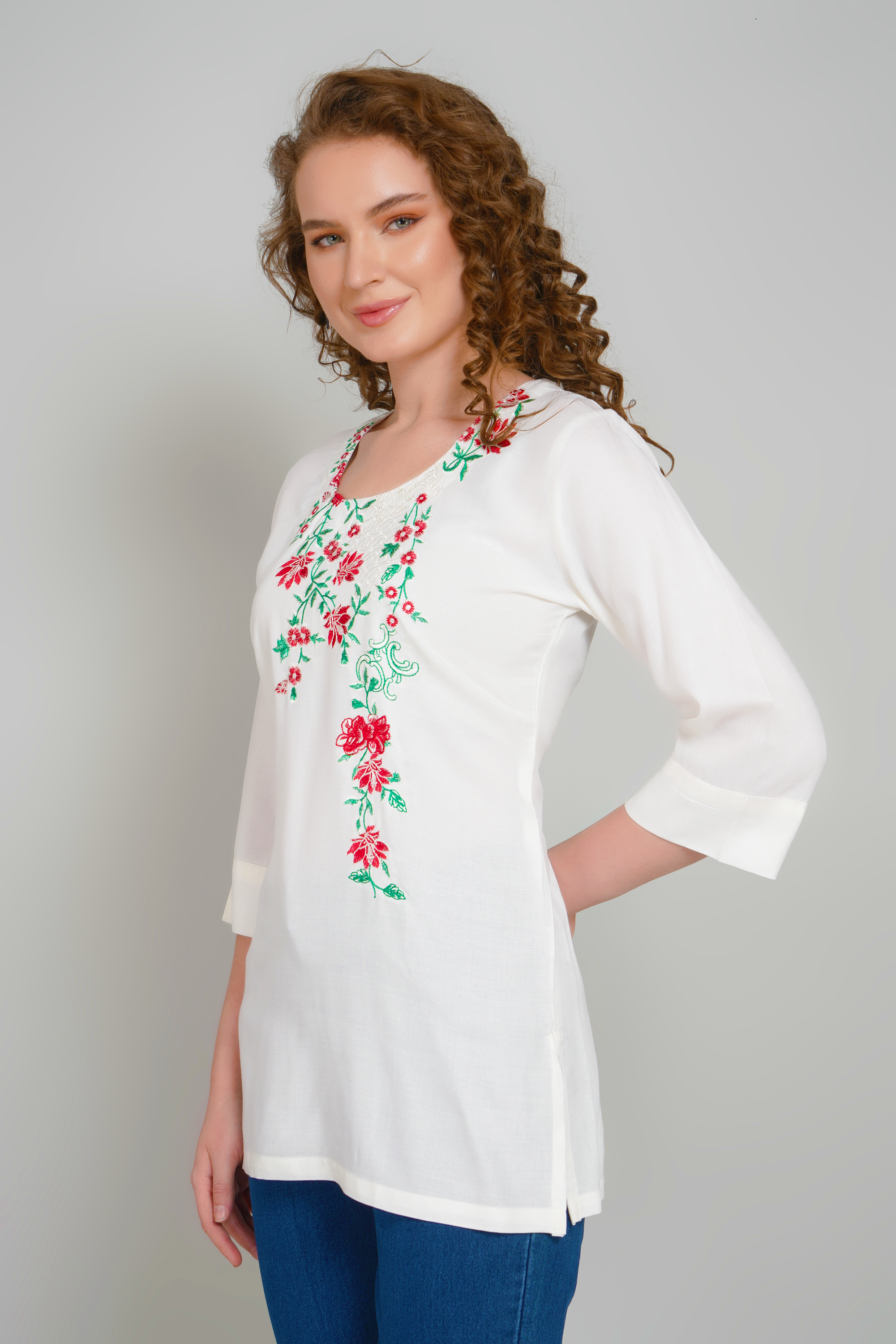 Women’s off-white tunic with floral embroidery across the V-neckline