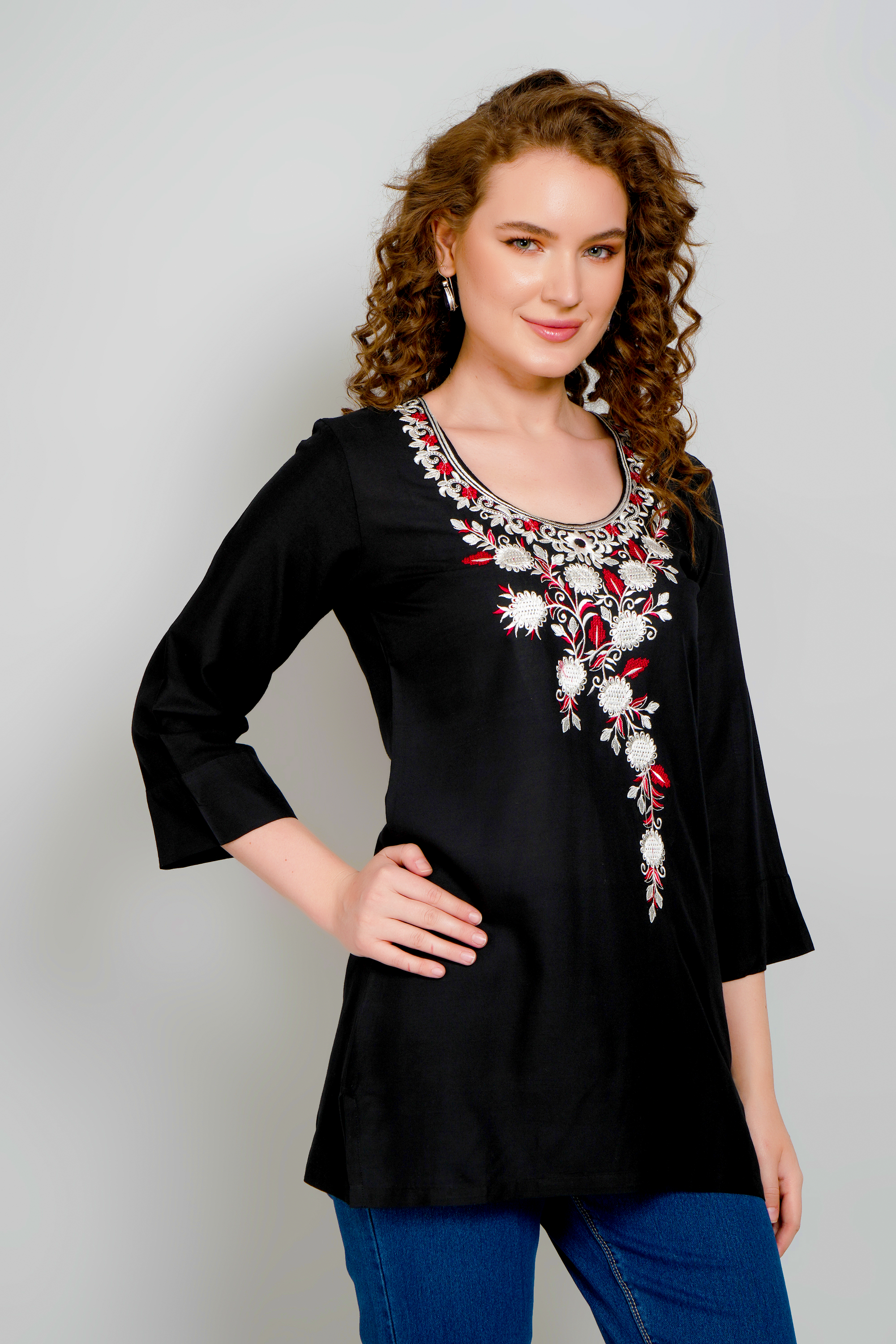 Women's black short kurta with ornate floral embroidery across neckline and chest