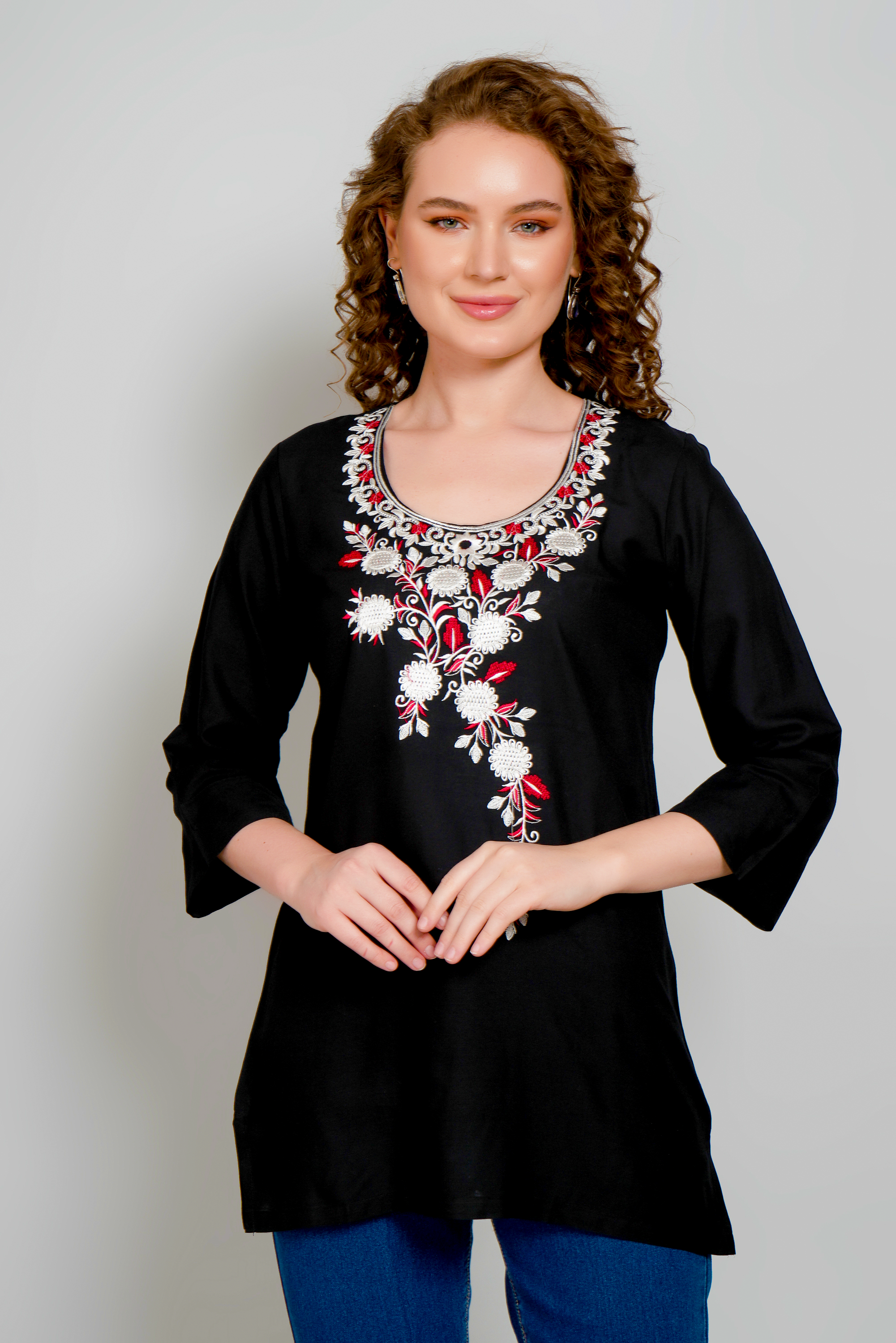 Women's black short kurta with floral embroidery on neckline, relaxed A-line shape