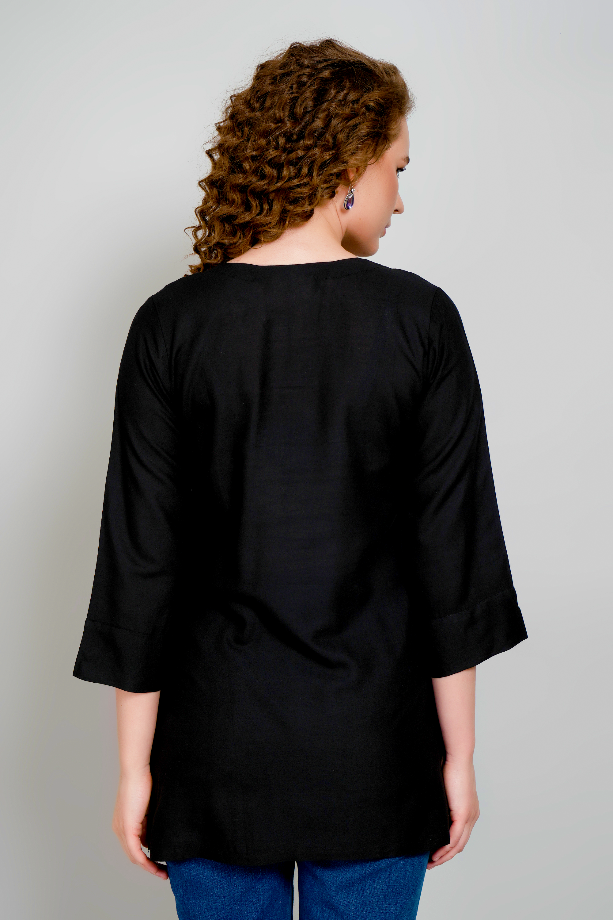 Women's black short kurta back view, three-quarter sleeves and straight hem