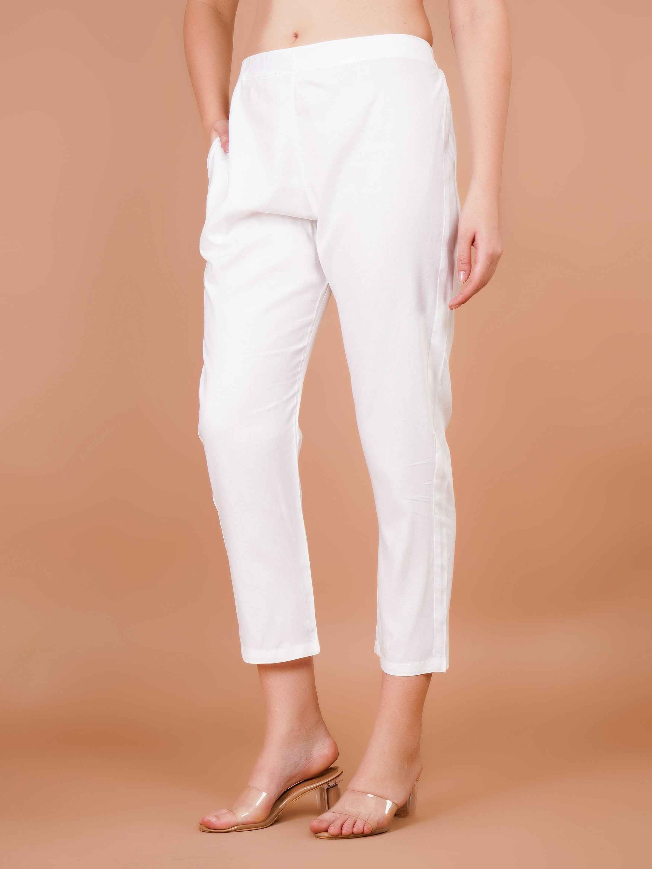 Women's white capri trousers, side view, tapered fit and cuffed ankle hem