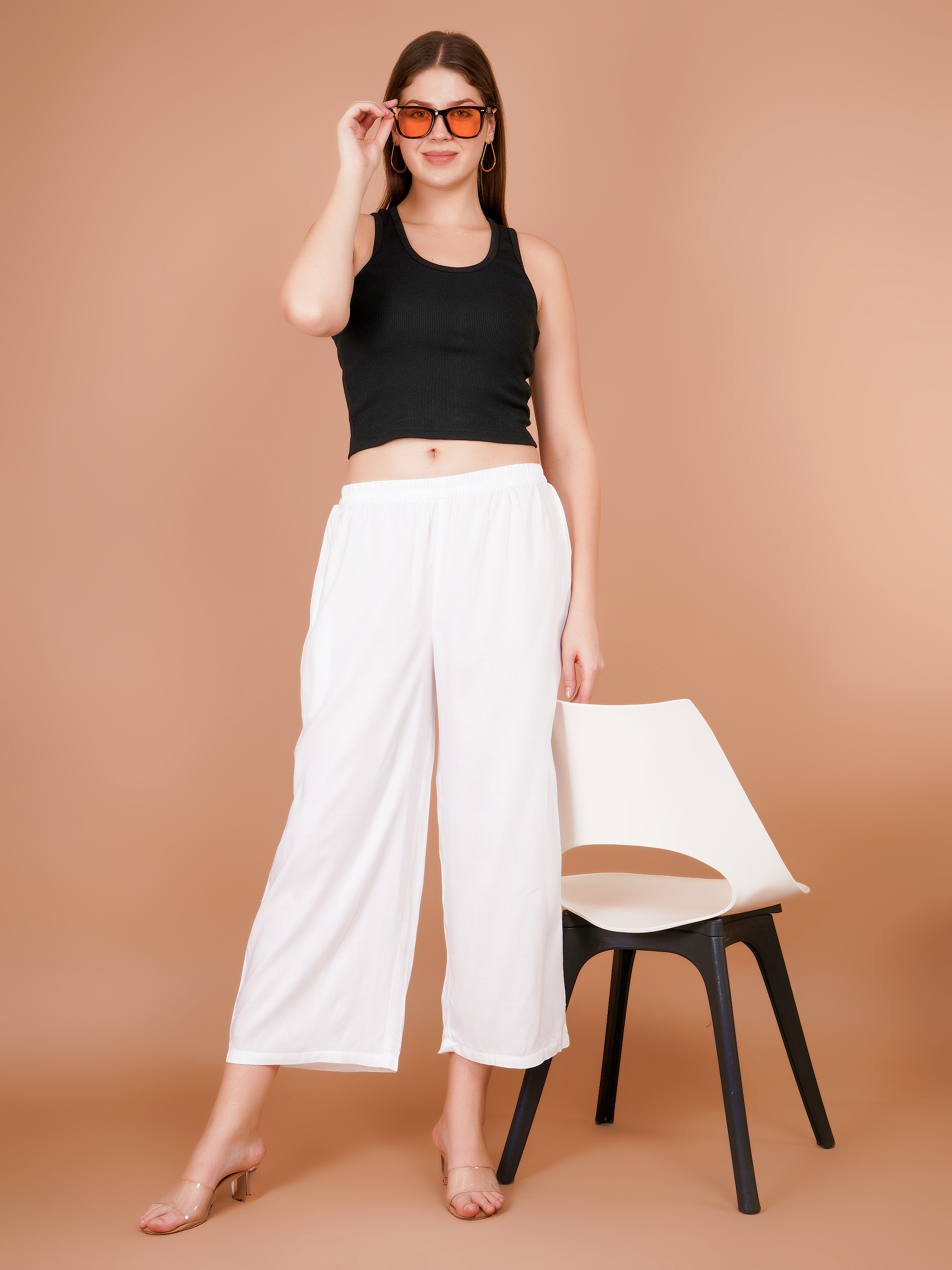 Women’s white palazzo pants with elastic waist and wide leg drape, front view