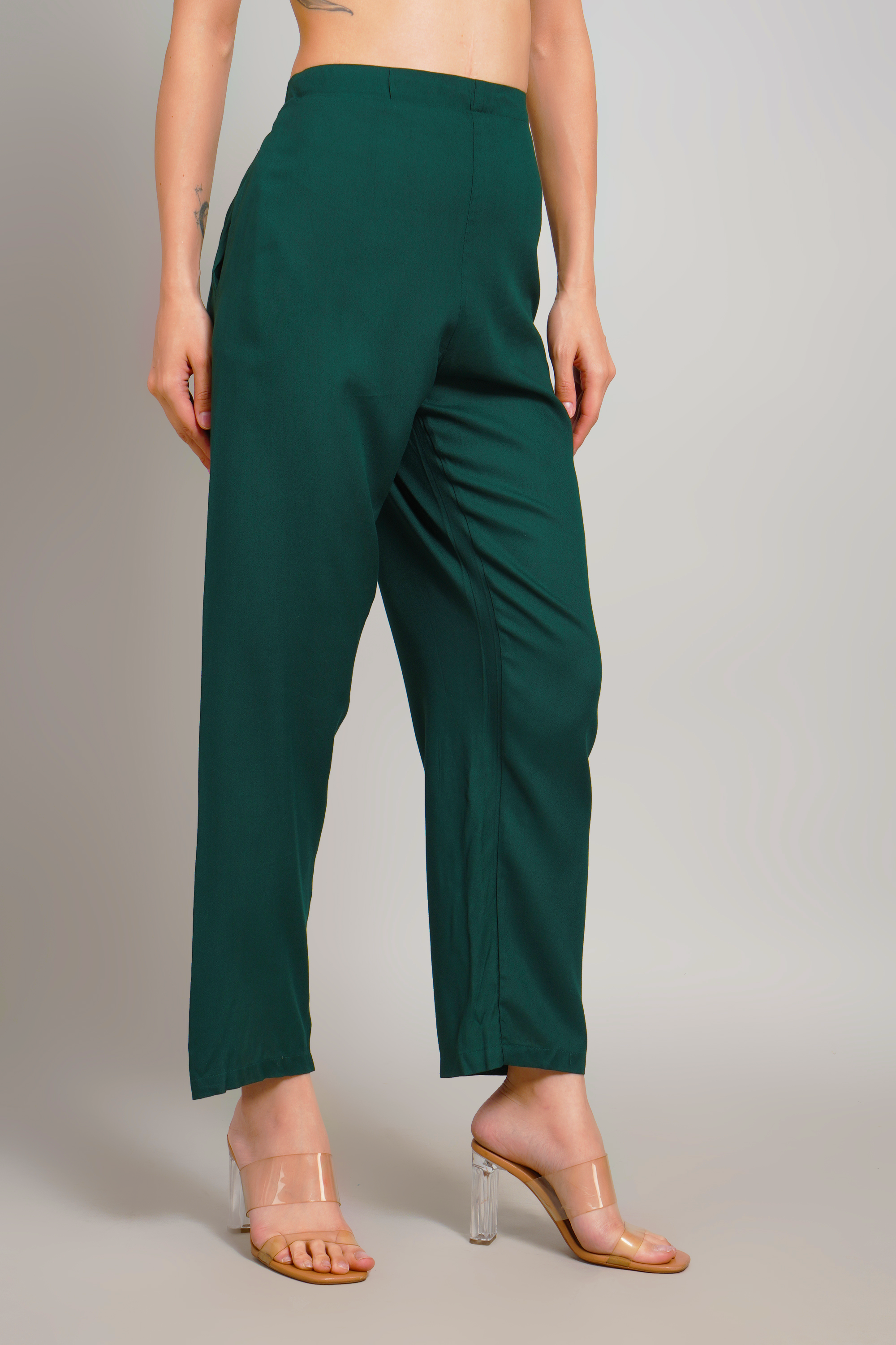 Women’s dark green trousers back view with ruched waistband and center seam