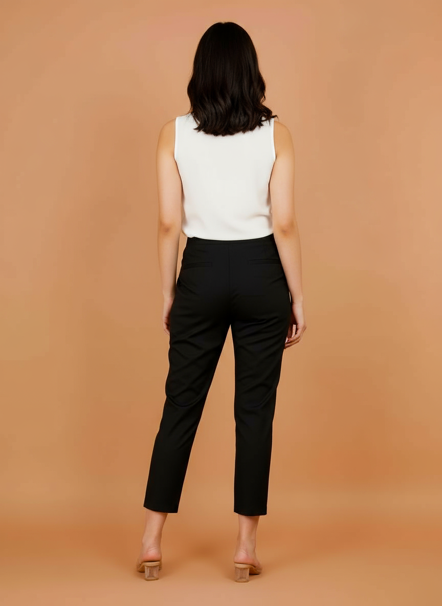 Women's black cropped trousers, back view with elastic waist.