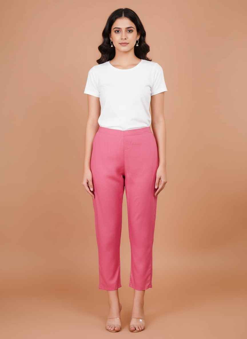 Women’s pink trousers with elastic waistband and cuffed hem, worn with a white tee
